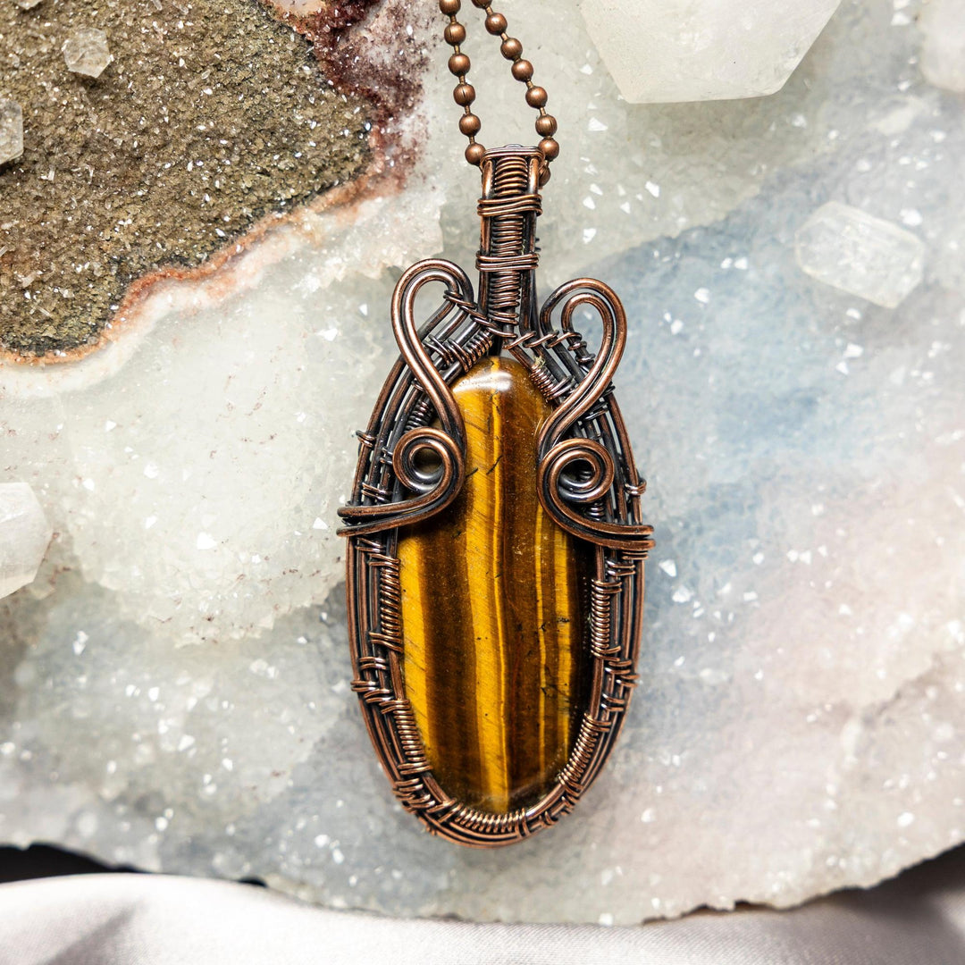 3" Tiger's Eye Wire Wrap Pendant: golden-brown chatoyant stone in handcrafted healing copper, promoting protection.