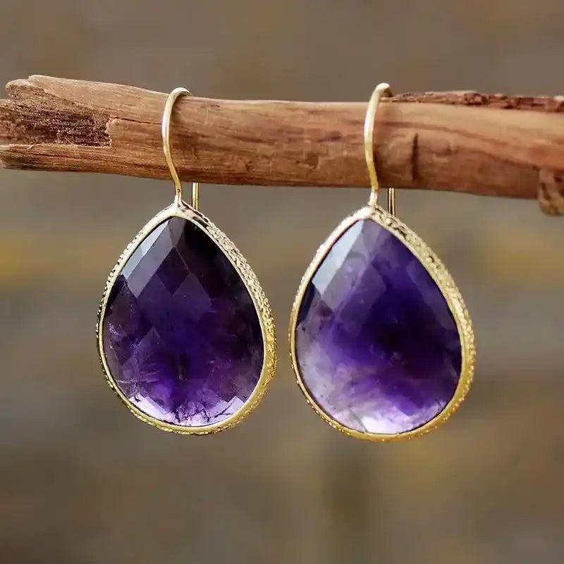 Sparkling Amethyst Teardrop Dangle Earrings with gold-tone settings, offering timeless sophistication and versatile style.