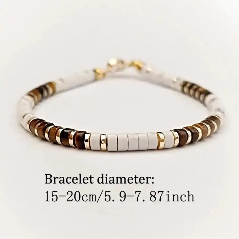 Tiger's Eye and white stone disc bead bracelet with gold-tone spacers for grounded confidence and elegant style.
