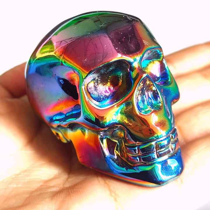 2.36'' Titanium Aura Obsidian skull carving featuring a vibrant, iridescent rainbow finish for powerful energy healing.