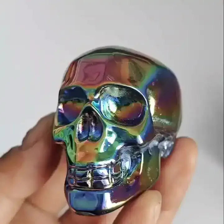2.36'' Titanium Aura Obsidian skull carving with a vibrant, iridescent rainbow finish for powerful energy healing.
