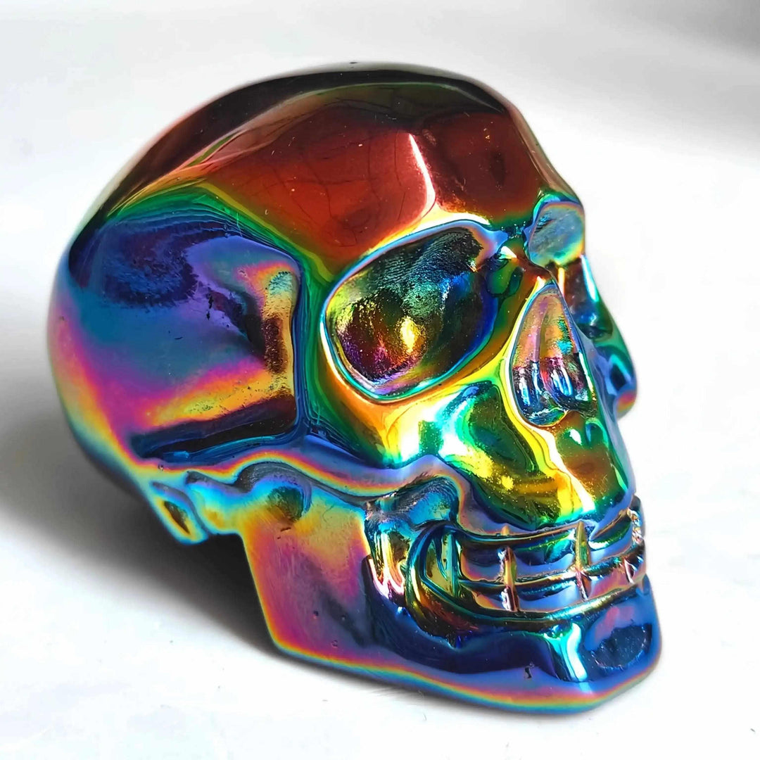 2.36'' Titanium Aura Obsidian skull carving featuring a vibrant, iridescent rainbow finish for powerful energy healing.