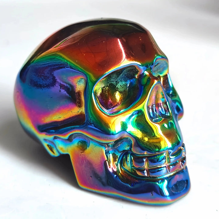 2.36'' Titanium Aura Obsidian skull carving featuring a vibrant, iridescent rainbow finish for powerful energy healing.