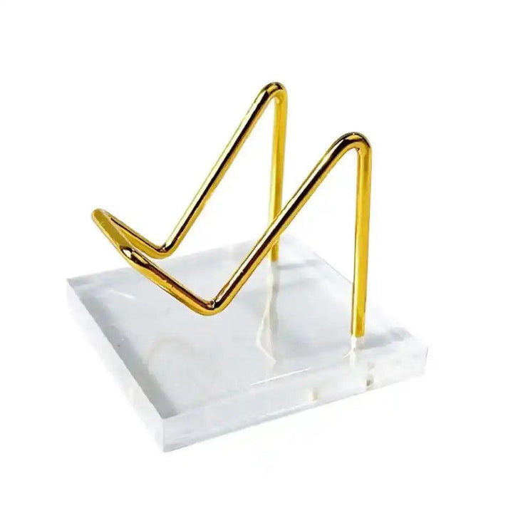 Elegant gold wire and clear acrylic display stand for crystals, gemstones, or sacred objects, promoting clarity and positive energy.