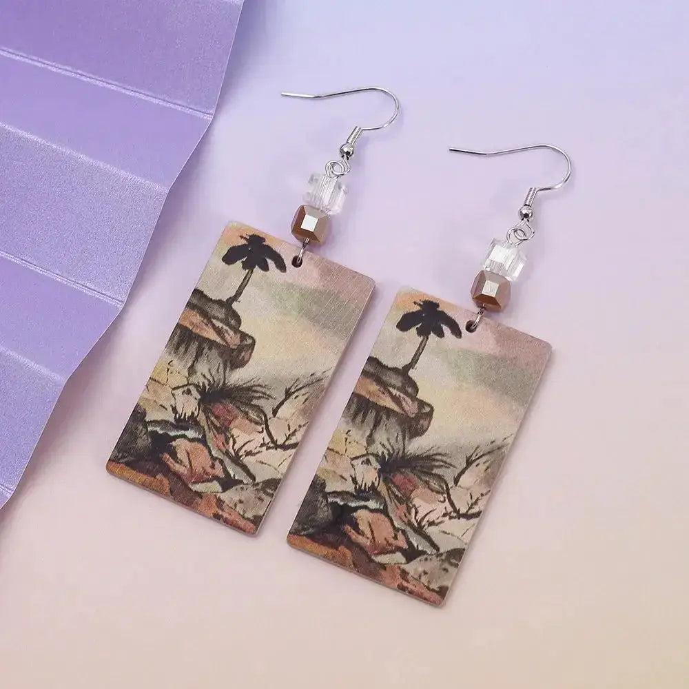 New Style Tree of Life Acrylic Earrings with gold-colored relief printing, clear crystal beads, and silver hooks.