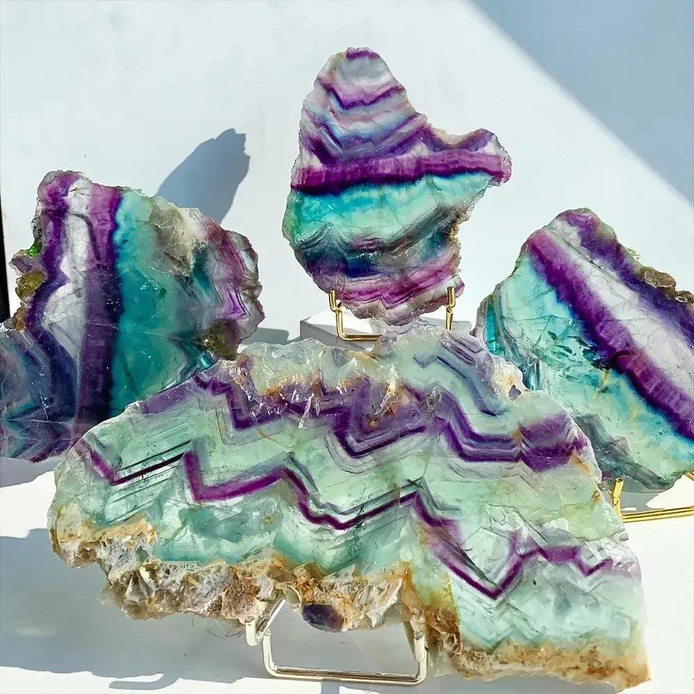 Vibrant trichrome fluorite slices from Crystal Destiny, showcasing purple, green, and blue bands for clarity and healing.