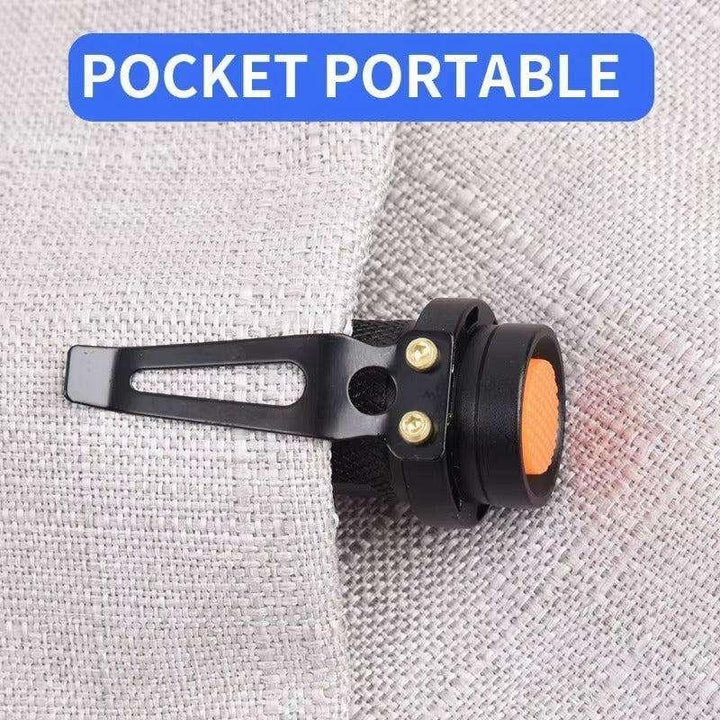 Black UV-365nm AA battery flashlight with an orange lens, clipped to a gray fabric, highlighting its pocket-portable design.