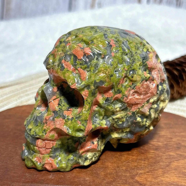 Hand-carved Unakite crystal skull with green and pink mineral patterns, perfect for Reiki healing and home decor.