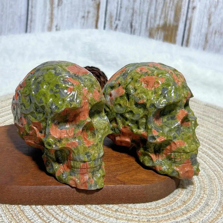 Hand-carved Unakite crystal skull for healing, featuring vibrant green and pink mineral patterns for unique home decor.
