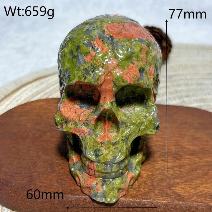Hand-carved 659g Unakite crystal skull featuring vibrant green and pink healing stone patterns for unique home decor.