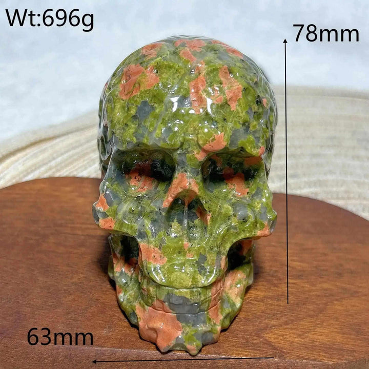 Hand-carved 696g Unakite crystal skull with green and pink healing stone patterns, perfect for Reiki or home decor.