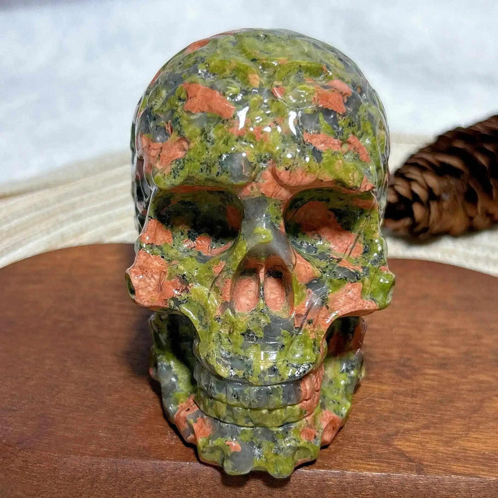 Polished Unakite crystal skull hand carving with green and pink mineral patterns for healing energy and home decor.