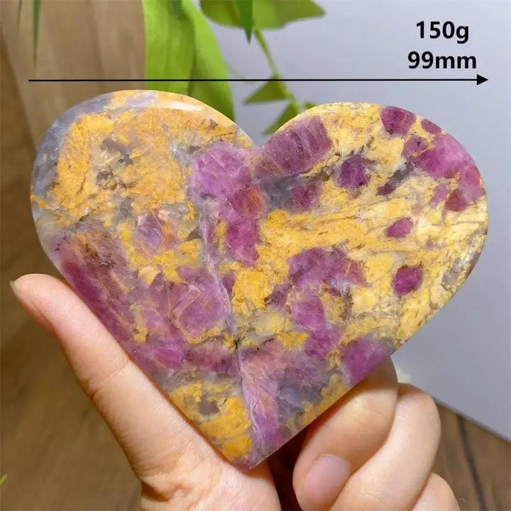 Polished Unicorn Stone heart, 150g, 99mm, with swirling pink, purple, and yellow natural patterns.