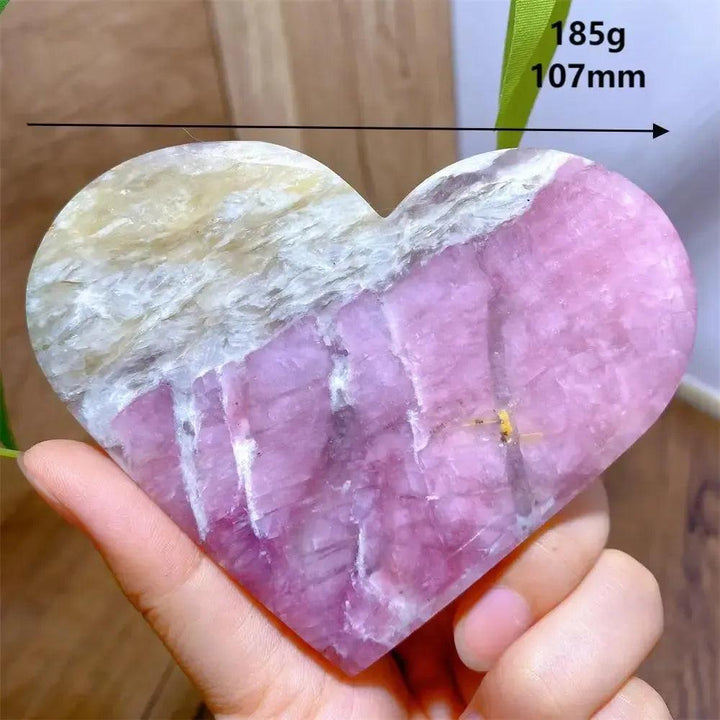 Hand-carved Unicorn Stone heart, 185g, 107mm, with swirling pink, grey, and purple hues.
