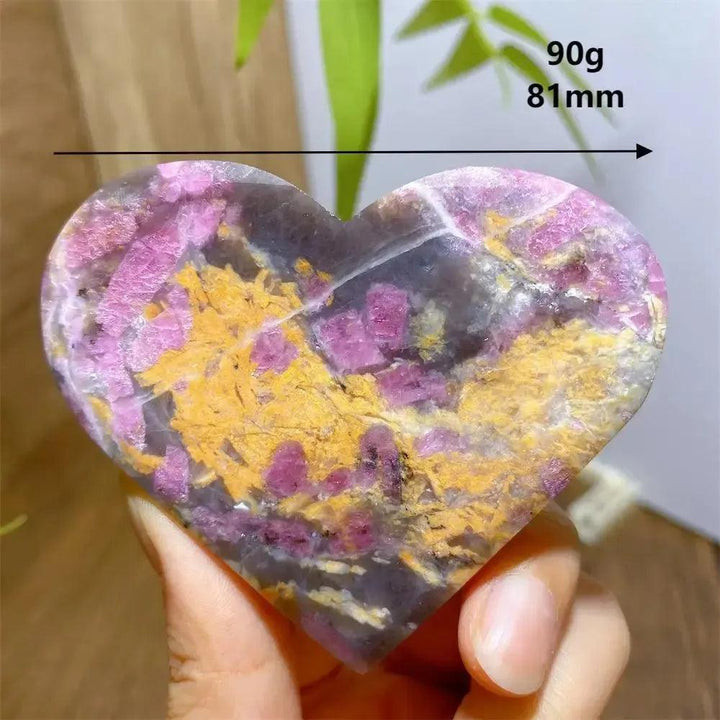 Unicorn Stone heart, 90g, 81mm, with swirling pink, grey, and yellow patterns.