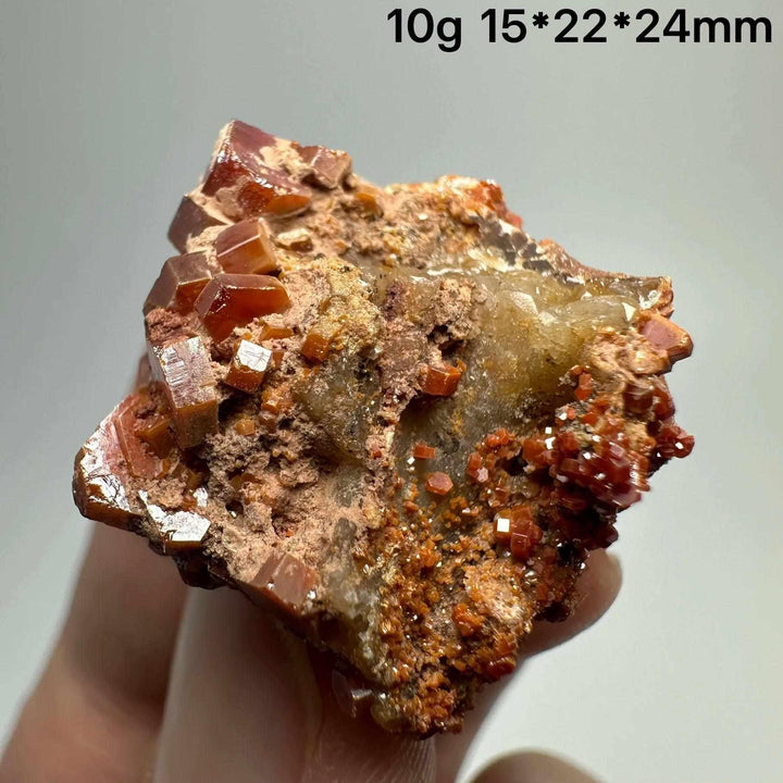 Vivid red hexagonal Vanadinite crystal specimen on natural matrix, perfect for Root Chakra energy and mineral collections.
