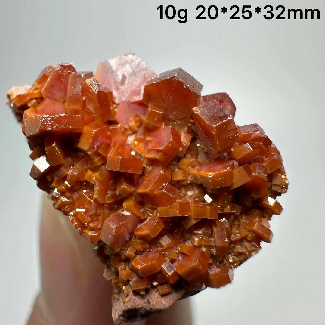 Vivid red hexagonal Vanadinite crystal specimen on natural matrix, perfect for Root Chakra energy and display.