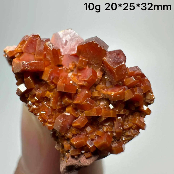 Vivid red hexagonal Vanadinite crystal specimen on natural matrix, perfect for Root Chakra energy and display.