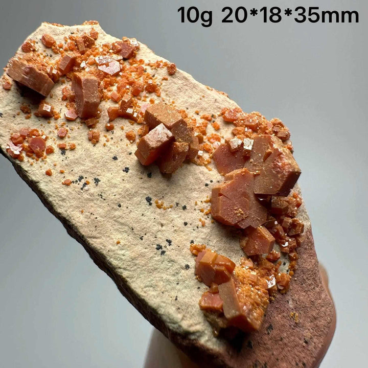 Vivid red hexagonal Vanadinite crystal specimen on natural matrix, perfect for Root Chakra energy and mineral collections.