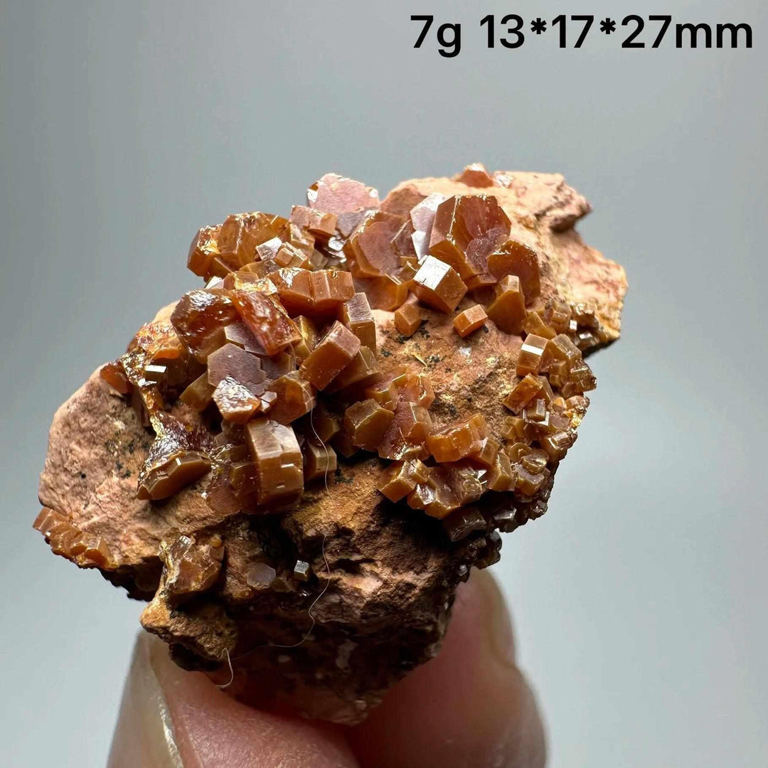 Vivid red hexagonal Vanadinite crystal specimen on a natural matrix, perfect for Root Chakra energy and mineral displays.