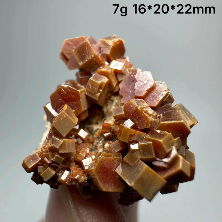 Vivid red-orange hexagonal Vanadinite crystals on a natural matrix, perfect for Root Chakra energy and mineral collections.