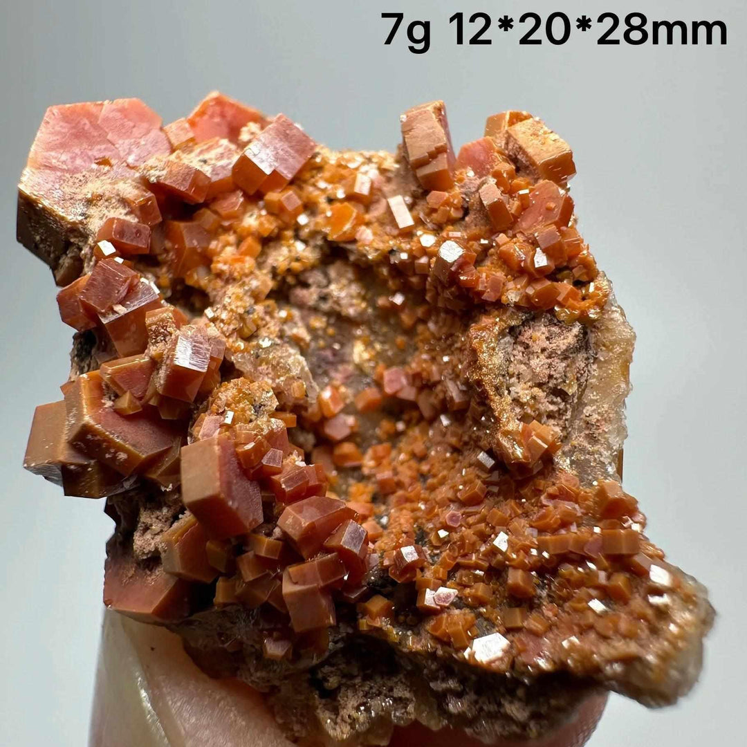 Vivid red hexagonal vanadinite crystals on a natural matrix, perfect for Root Chakra energy and mineral display.