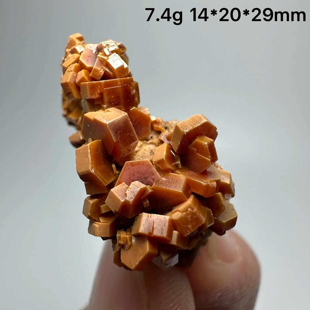Vivid red-orange hexagonal Vanadinite crystal specimen on natural matrix, perfect for Root Chakra energy and display.
