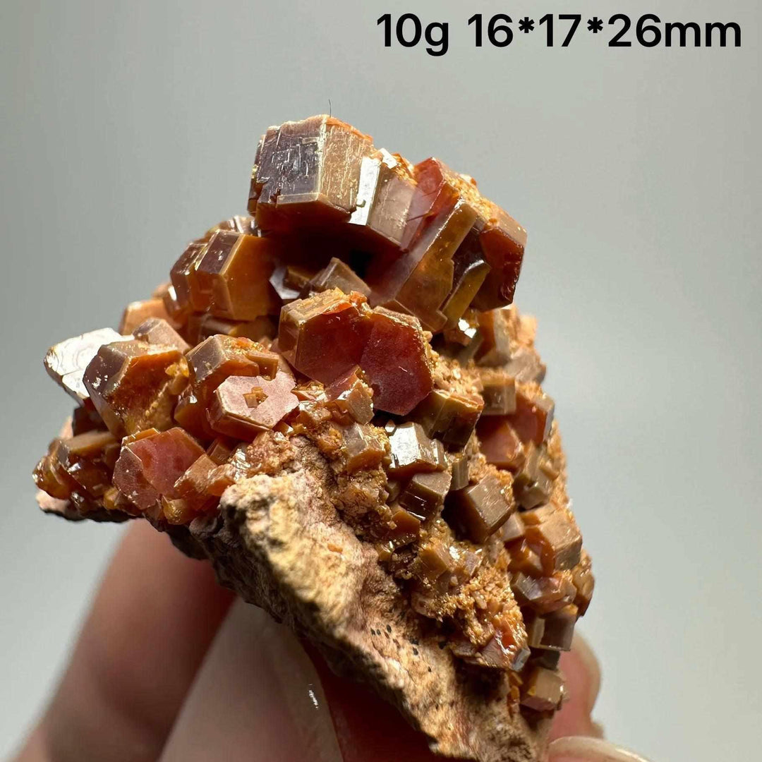 Vivid red hexagonal Vanadinite crystal specimen on natural matrix, perfect for Root Chakra energy and mineral collections.