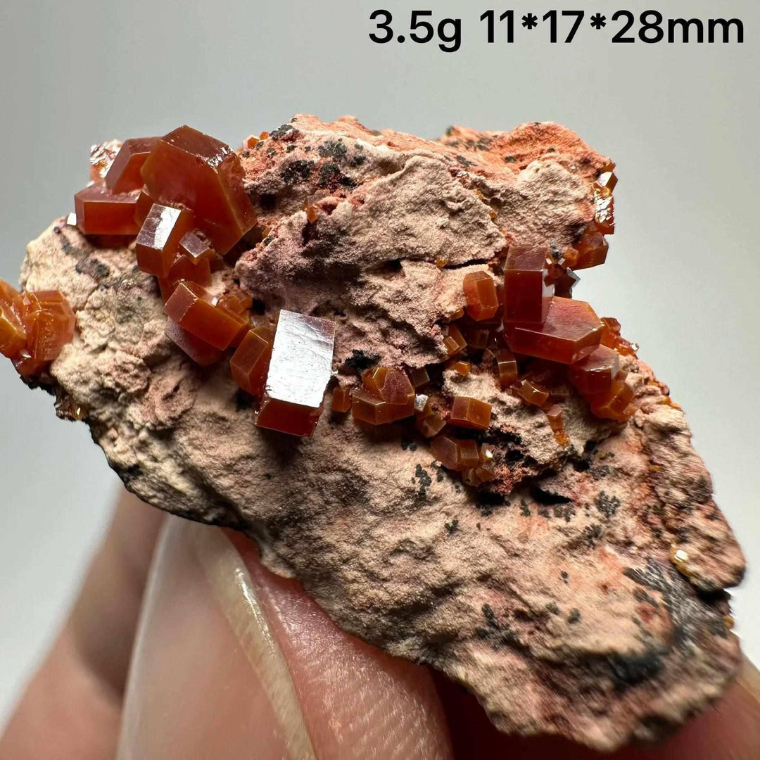 Vivid red hexagonal Vanadinite crystals on natural matrix, a grounding specimen for Root and Sacral Chakra energy.