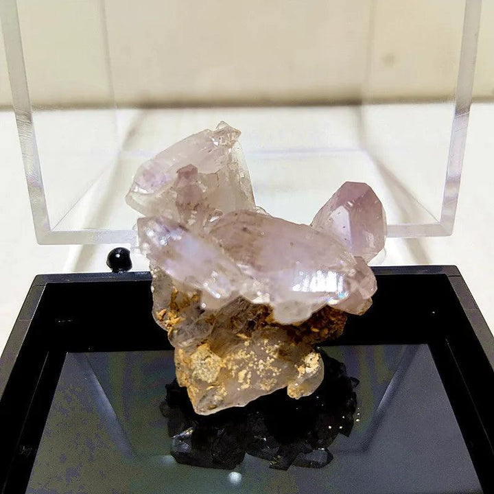 Raw Vera Cruz Amethyst cluster with pale lavender points, showcasing natural clarity and high-vibration energy.