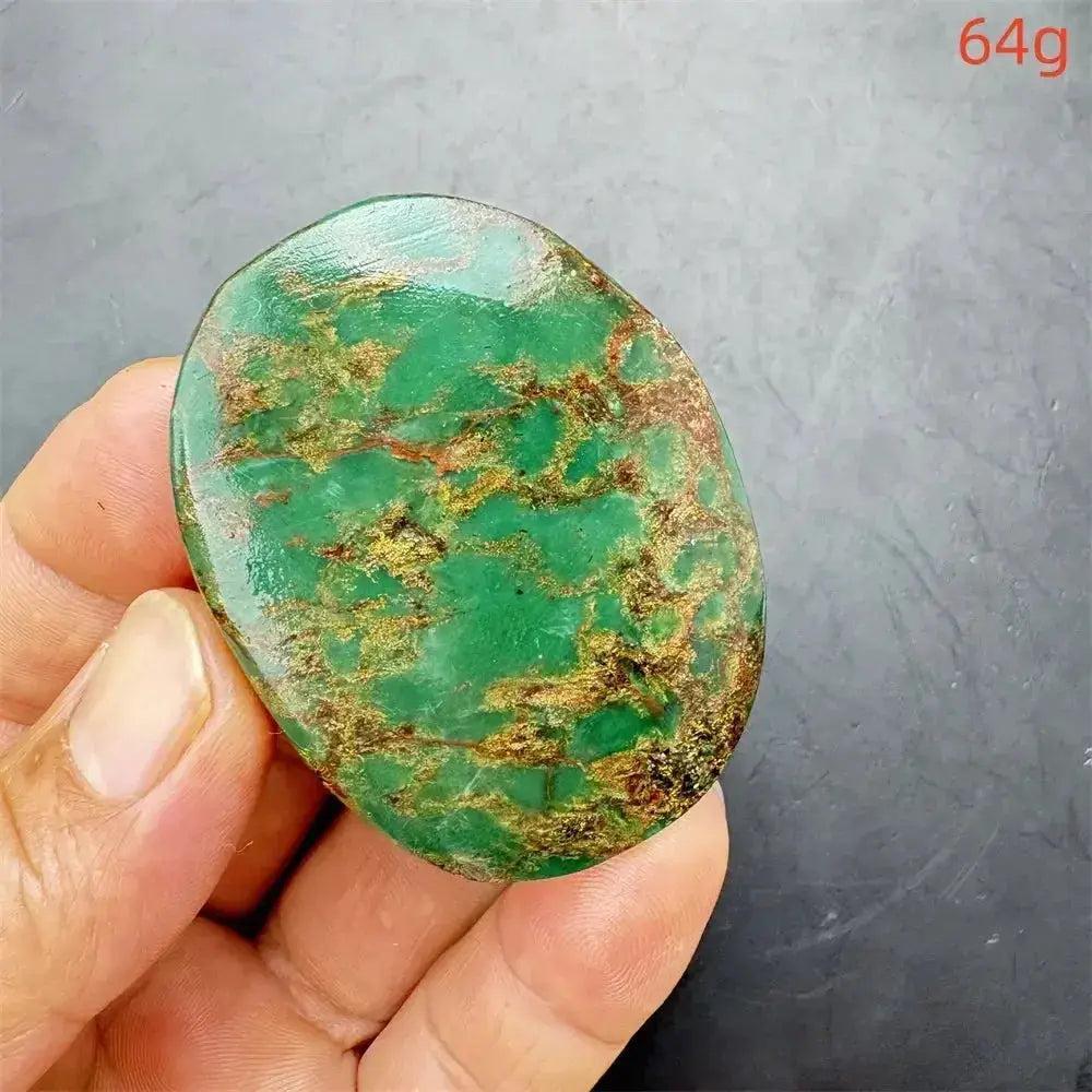 Polished Verdite crystal palm stone, deep mottled green with gold and rust flashes, held in hand, 64g.