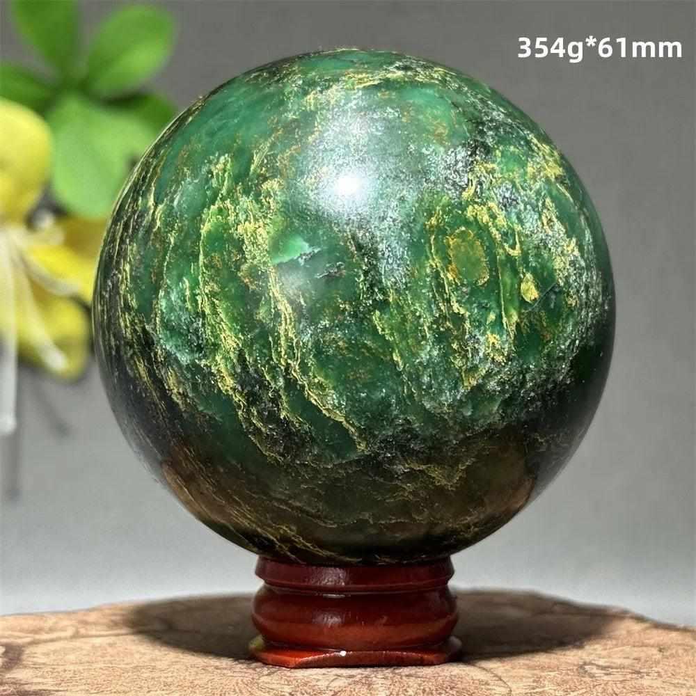 Polished 61mm verdite sphere in deep green with natural shading, perfect for grounding and heart chakra meditation.
