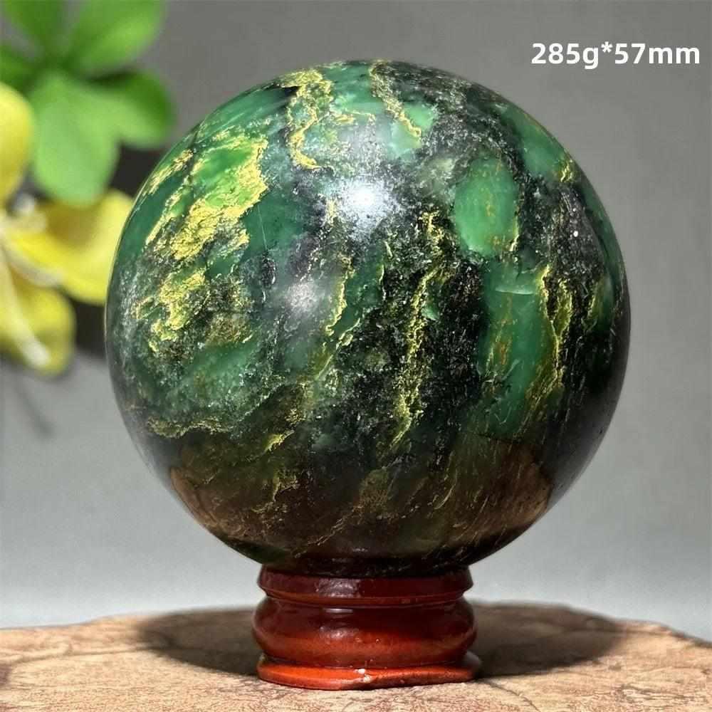 Polished 57mm verdite sphere in deep green with natural shading, perfect for heart chakra grounding and abundance.