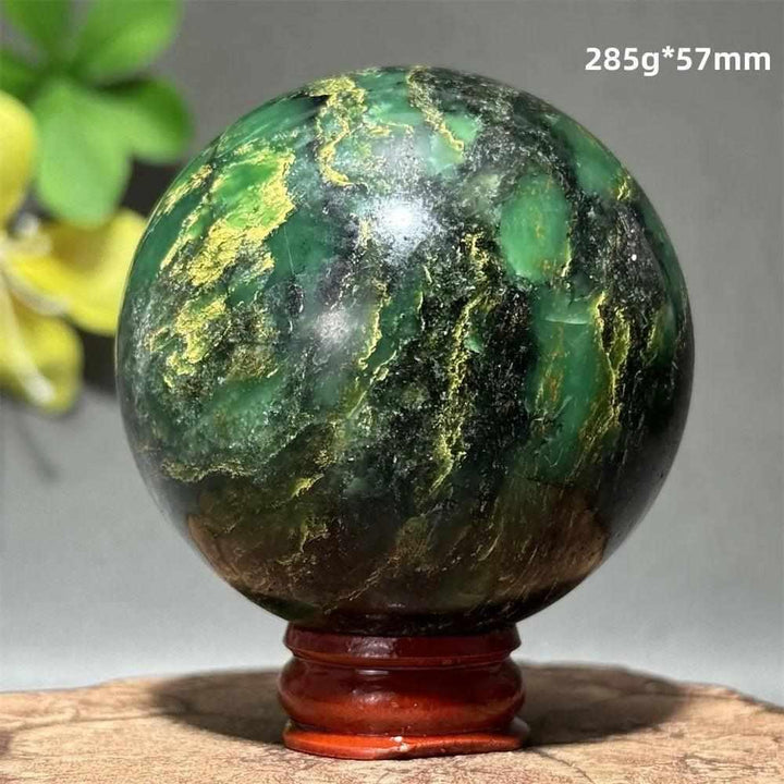 Polished 57mm verdite sphere in deep green with natural shading, perfect for heart chakra grounding and abundance.