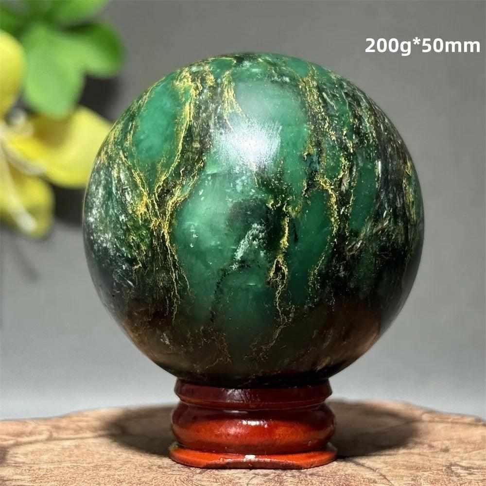 Polished 50mm verdite sphere in deep green with natural shading, perfect for grounding and heart chakra meditation.