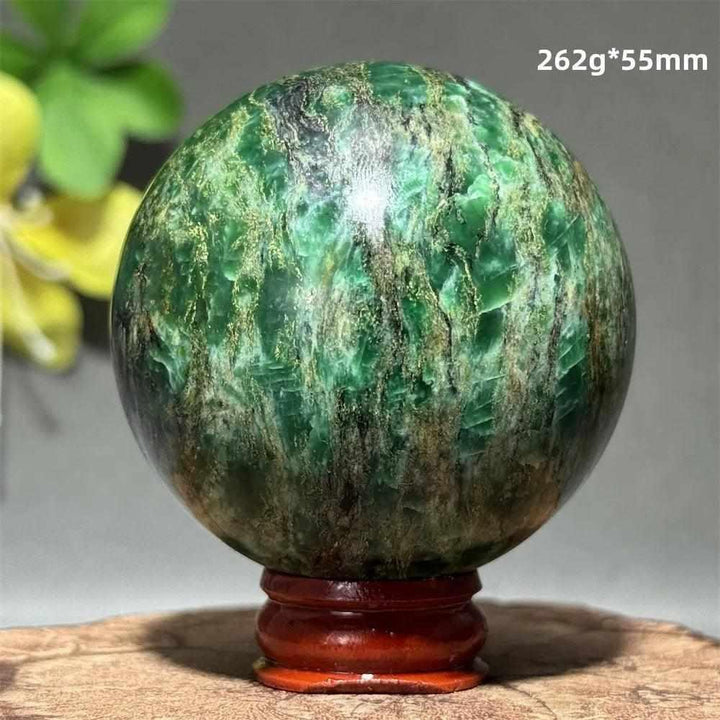 Polished 55mm verdite sphere with deep green shading for heart chakra grounding, growth, and abundance.