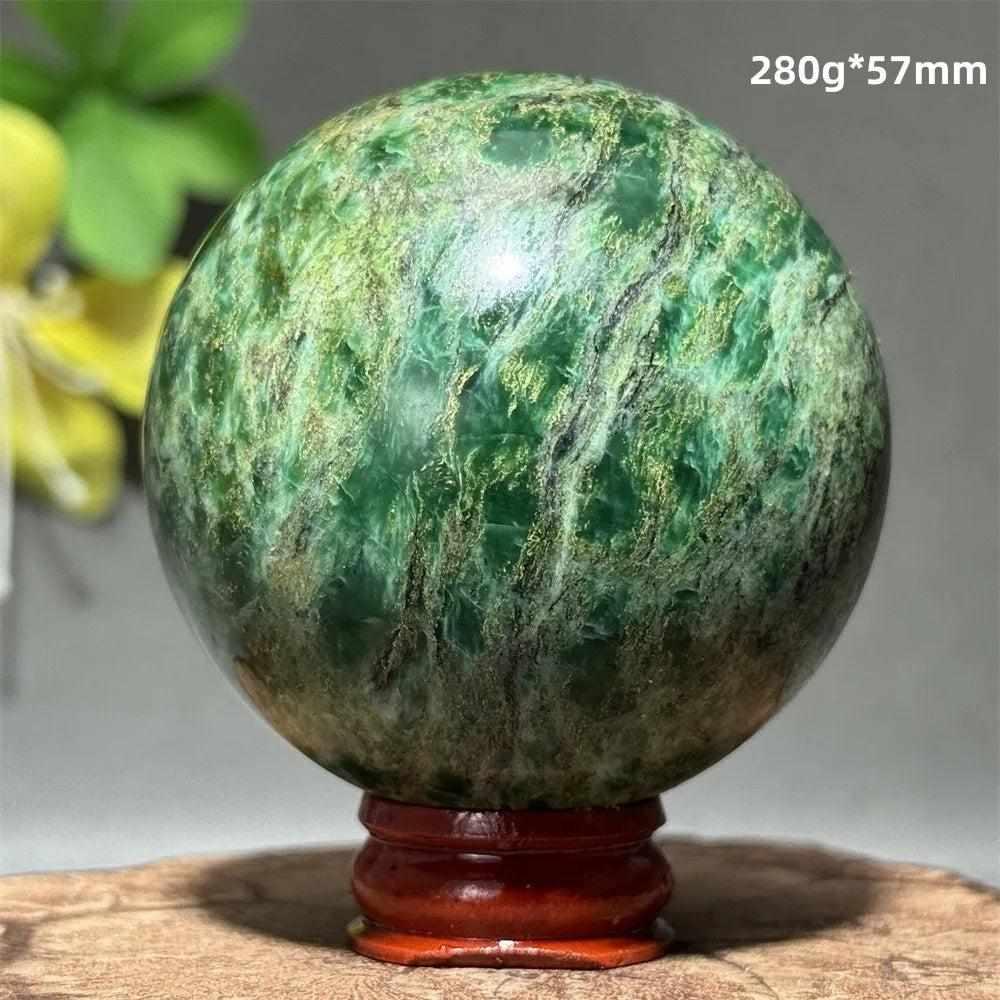 Polished 57mm verdite sphere in deep green with natural shading, perfect for heart chakra grounding and meditation.