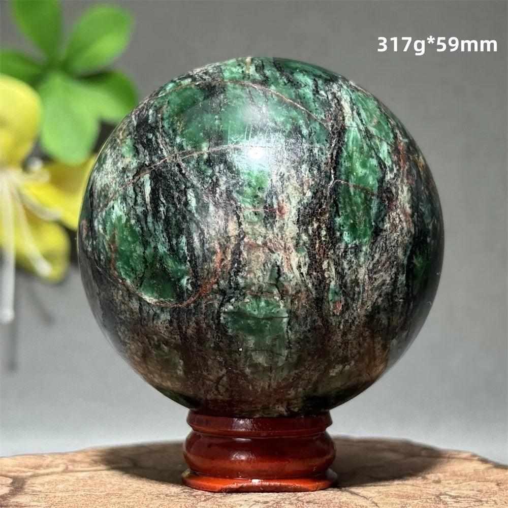 Polished 59mm verdite sphere in deep green with natural shading, perfect for grounding and heart chakra meditation.