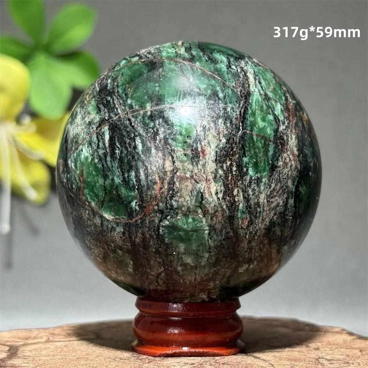 Polished 59mm verdite sphere in deep green with natural shading, perfect for grounding and heart chakra meditation.