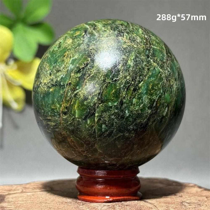 Polished 57mm verdite sphere in deep green with natural shading, perfect for grounding and heart chakra meditation.