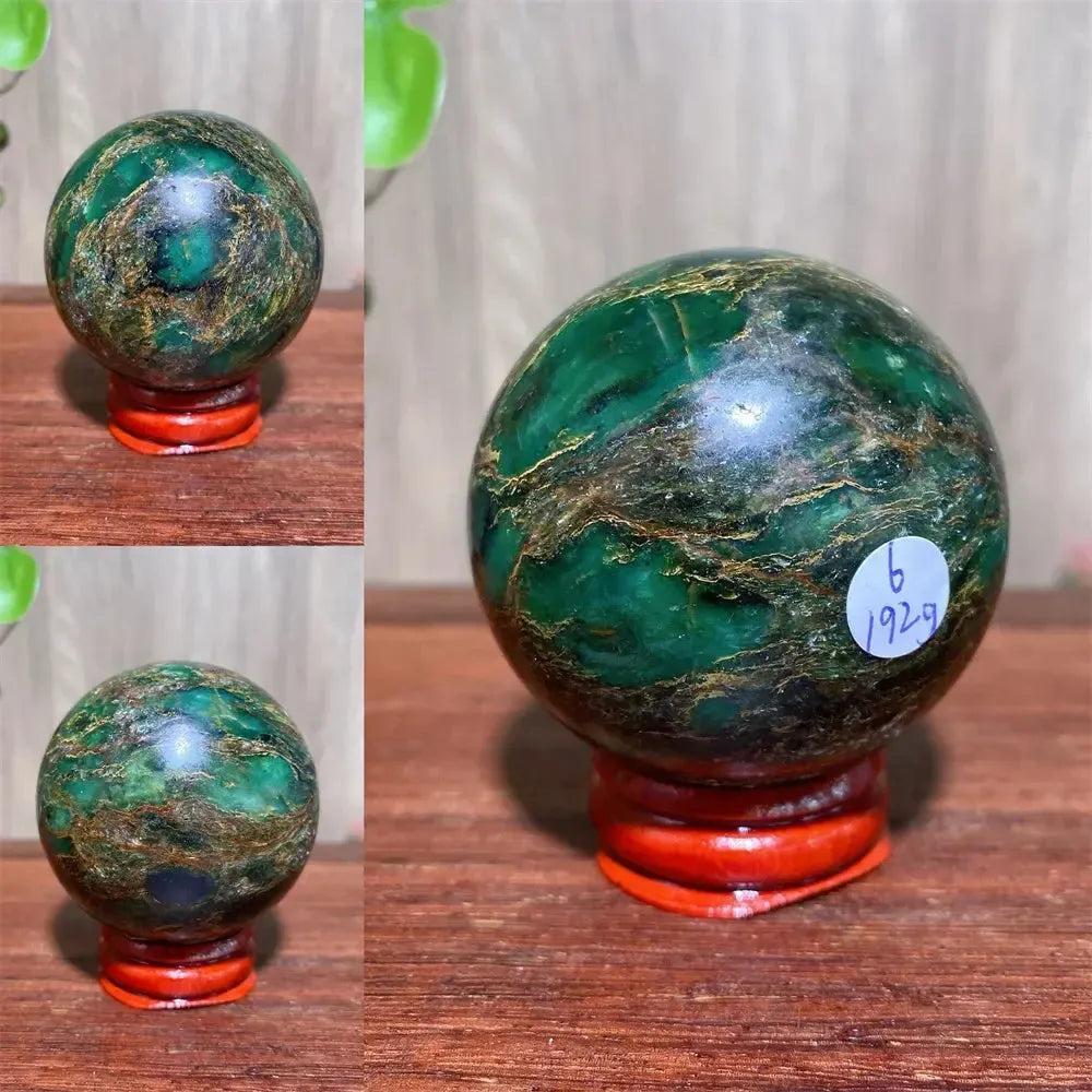 Verdite sphere with deep forest green and shimmering gold veins on a red display stand.