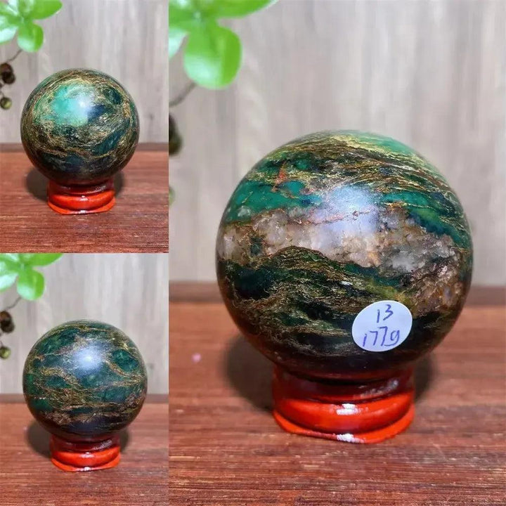 Verdite sphere with deep forest green and shimmering gold veins on a red display stand.