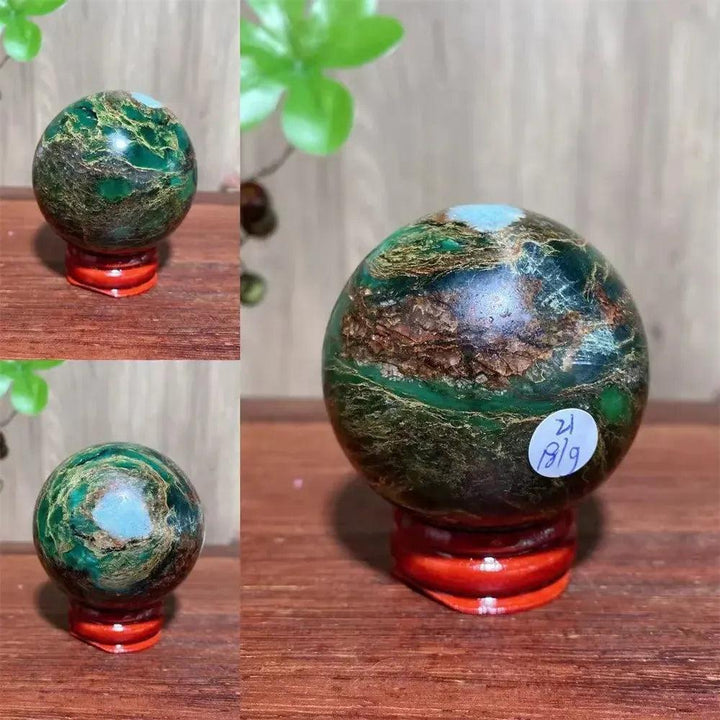 Verdite sphere with deep forest green and shimmering gold veins on a reddish-brown wooden stand.