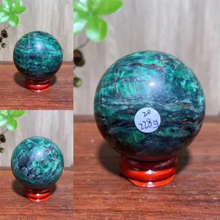 Verdite sphere with deep forest green and shimmering gold veins on a red display stand.