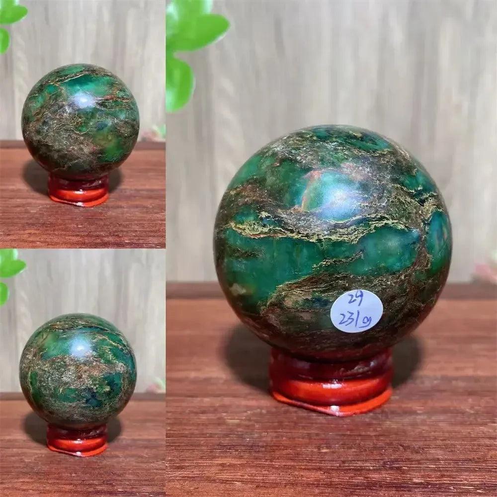 Verdite sphere with deep forest green and shimmering gold veins on a red display stand.