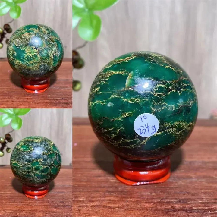 Verdite sphere with deep forest green and shimmering gold veins on a red display stand.