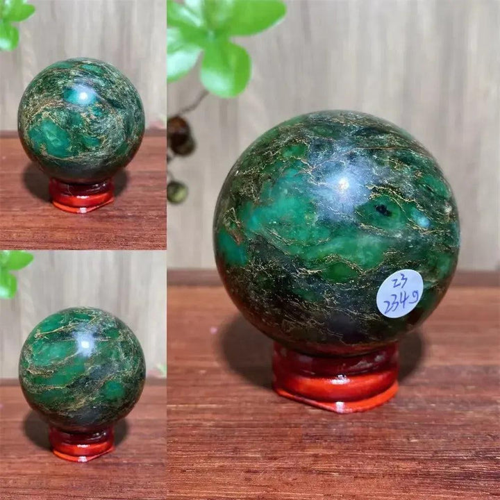 Verdite sphere with deep forest green and shimmering gold veins on a red display stand.