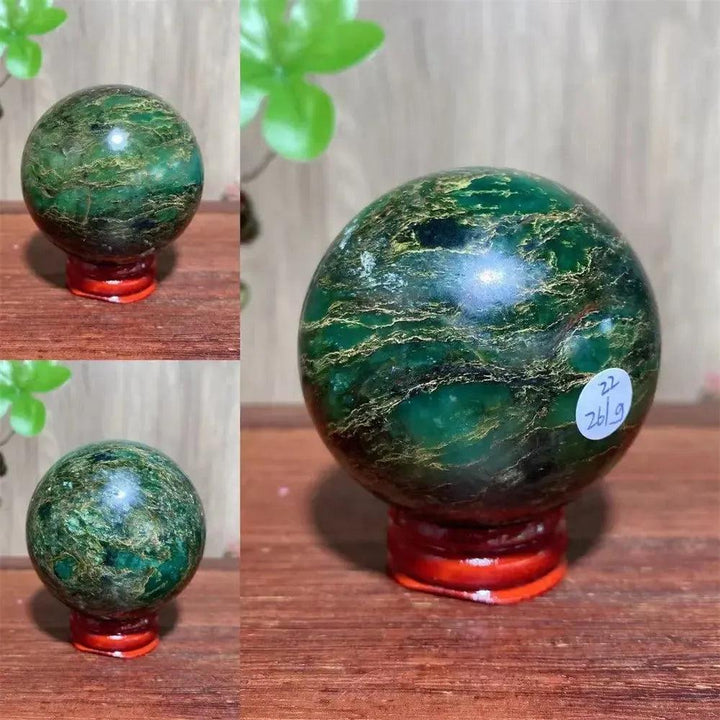 Verdite sphere with deep forest green and shimmering gold veins on a red display stand.