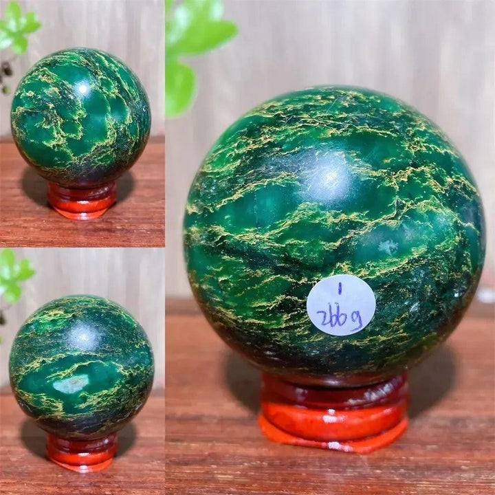 Verdite sphere: deep forest green crystal with shimmering gold veins, on a reddish-brown display stand.
