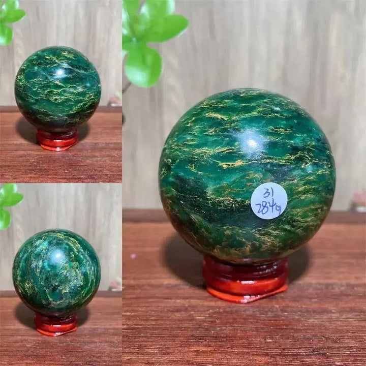 Verdite sphere with deep forest green and shimmering gold veins on a red wooden stand.